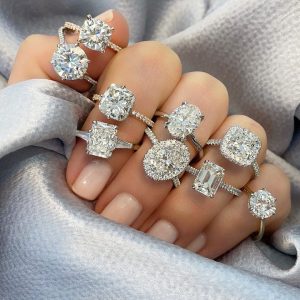 various diamond shape engagement rings on ladies hand